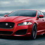 Red Jaguar XF with car mats